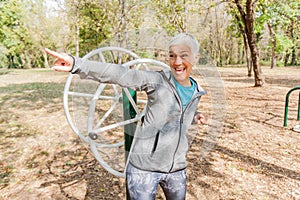 Happy Healthy Senior Woman Workout At Outdoor Gym In Nature