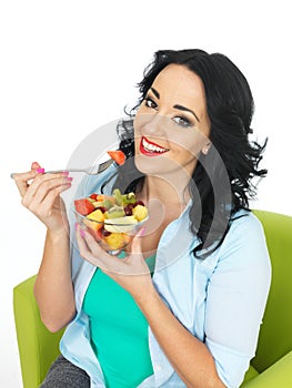 Happy Healthy Young Fit Woman Eating A Bowl Of Fresh Exotic Fruit Salad