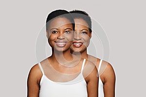 Happy healthy young woman and senior women smiling looking at camera on white background. Aging, cosmetology, plastic surgery