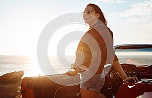 Happy heart, happy life. a happy young woman enjoying a summers road trip.