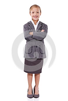 Happy in her office outfit. Adorable young girl standing with her arms crossed on isolated background.