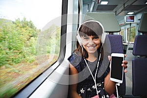 She is happy with her smart phone travelling by train
