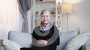 happy hijab woman positive attitude couch home