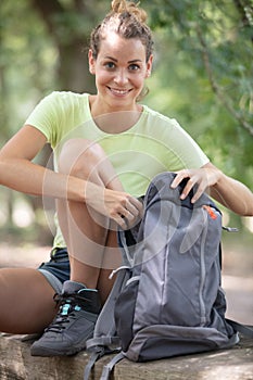 happy hiker looking in rucksack