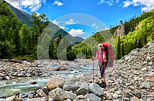 Happy hiker at mountain river