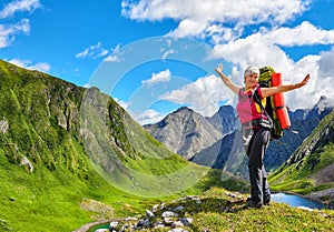 Happy hiker on top of hill in Siberian mountains