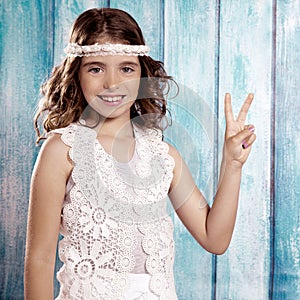 Happy hippie children girl smiling with peace hand sign