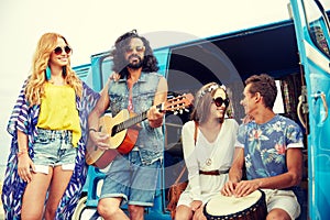 Happy hippie friends playing music over minivan