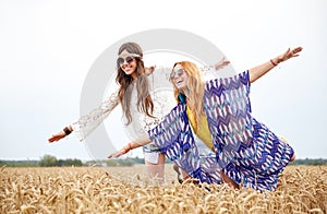 Happy hippie women having fun on cereal field