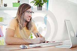 Happy hipster at computer desk