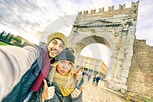 Happy hipster couple taking selfie at european city trip