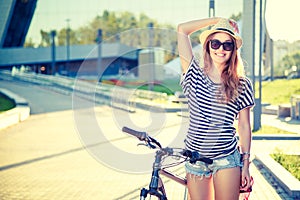Happy Hipster Girl with Bike in the City