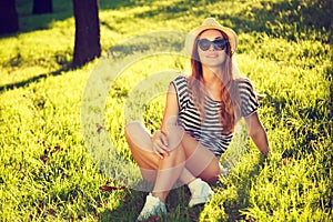 Happy Hipster Girl Relaxing on the Grass