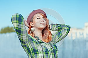 Happy hipster redhead girl in checkered shirt