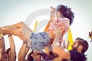 Happy hipster woman crowd surfing