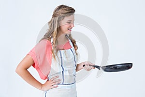 Happy hipster woman holding frying pan