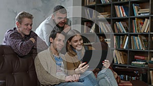 Happy hipsters making video call to friend at home