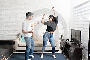 Smiling Latin Couple Dancing At Home