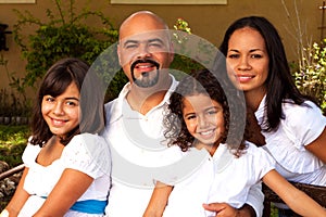 Happy Hispanic family laughing and smiling.