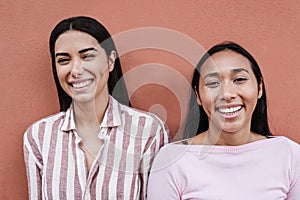 Happy hispanic girls having fun smiling on camera - Focus on right woman face