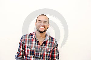 Happy hispanic guy in plaid shirt