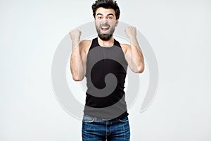 Happy hispanic man jumping from excitement out of frame