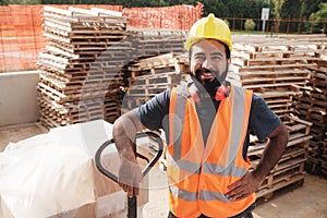 Happy Hispanic Manual Worker With Forklift Smiling At Camera