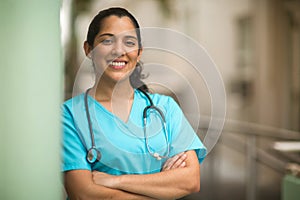 Happy Hispanic medial provider at work stock photo.