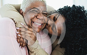 Happy Hispanic mother and daughter having tender moment together