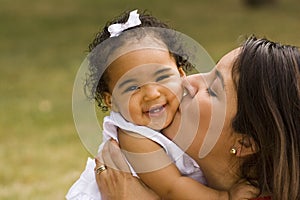 Happy Hispanic mother and her little girl.