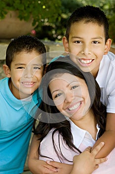 Happy Hispanic mother and her sons.