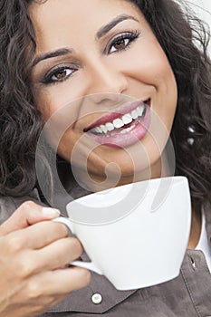 Happy Hispanic Woman Smiling Drinking From a Cup