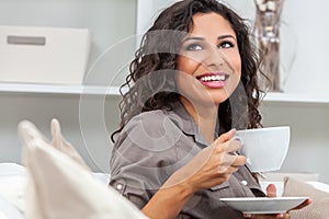 Happy Hispanic Woman Smiling Drinking Tea or Coffee at Home