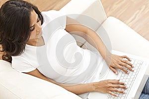 Happy Hispanic Woman Using Laptop Computer