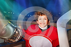 Happy hockey player standing next to the boards