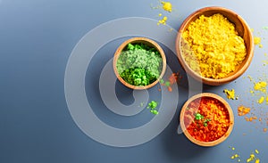 Happy Holi decoration, the indian festival.Top view of colorful holi powder on dark background