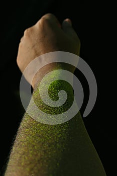 Happy Holi Greeting - Indian man with colourful hands, isolated over black background