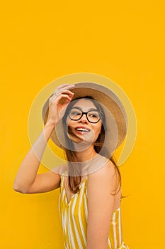 Happy holiday woman on a yellow background. City environment. beautiful smile