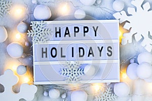 Happy holidays background. Creative layout made of greeting letters  with winter decoration. Flat lay