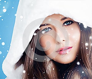 Happy holidays, beauty and winter fashion, beautiful woman wearing white fluffy fur coat, snowing snow on blue