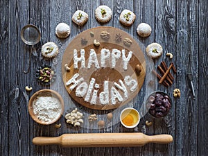 Happy holidays food background. Egg, flour and nuts are laid out on a dark background.