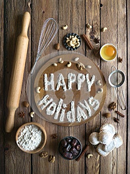 Happy holidays food background. Egg, flour and nuts are laid out on a wooden table.