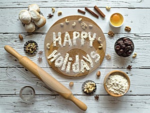Happy holidays food background. Egg, flour and nuts are laid out on a wooden table.
