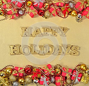 Happy Holidays golden text and Christmas decorations