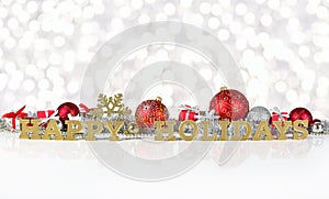 Happy holidays golden text and Christmas decorations