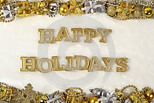 Happy holidays golden text and Christmas decorations on a white