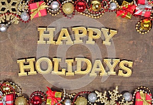 Happy holidays golden text and Christmas decorations