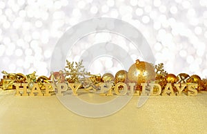 Happy holidays golden text and golden Christmas decorations