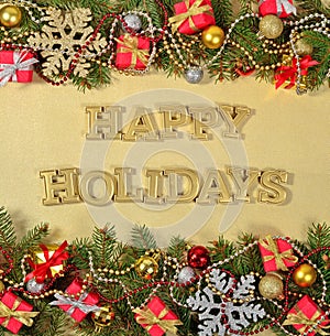 Happy holidays golden text and spruce branch and Christmas decor