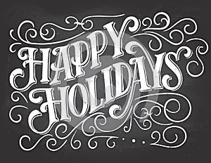 Happy holidays hand-lettering on chalkboard background photo